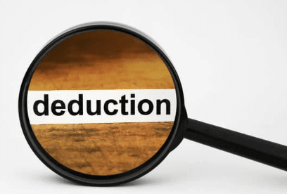 magnifying glass on the word "deduction" to illustrate how to use section 179 as a deduction on taxes